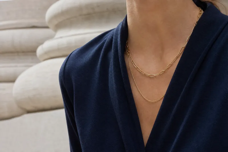 Layered chains at a wrap neckline